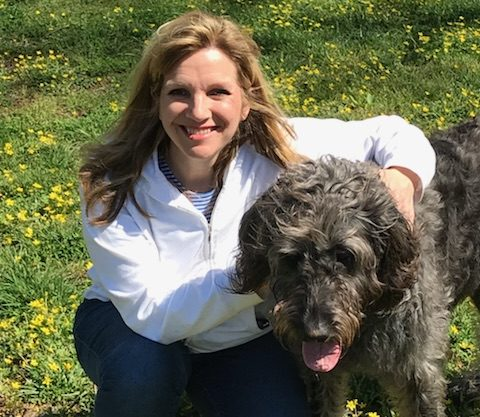 Laura Thomae Young outdoors with her dog Val